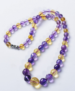 Synthetic ametrine -- no color variation within individual beads, and the "citrine" element is more yellow than golden.