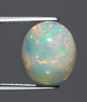 A gorgeous, genuine opal with irregular flashes of brilliant colors!